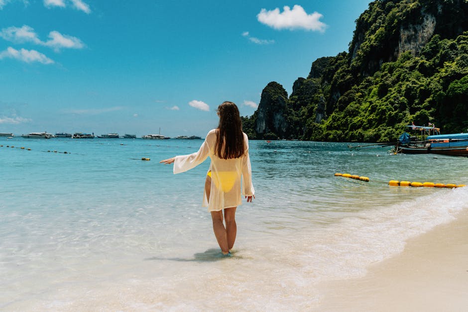 A woman enjoying a sunny day at the beach in Ko Panyi, Thailand with stunning sea views.