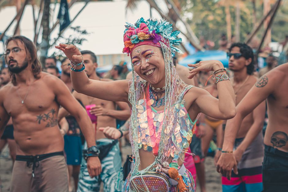 Exciting beach party with people dancing, enjoying music and colorful outfits