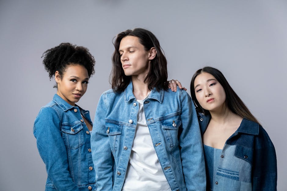 Three diverse models posing in denim jackets in a studio portrait setting.