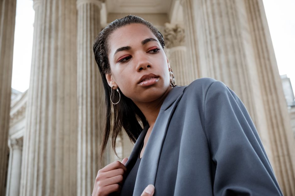 Stylish woman in front of Kazan Cathedral's neoclassical columns, exuding elegance.