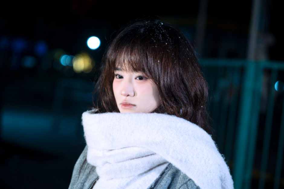 Portrait of a young woman with scarf in a nighttime winter setting