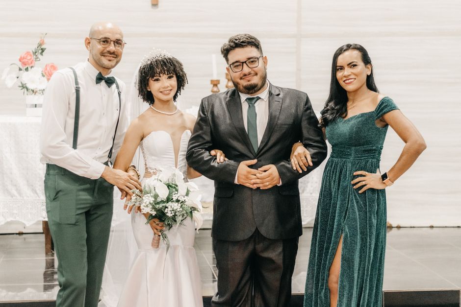 A beautiful wedding scene with a joyful bride, groom, and guests indoors.